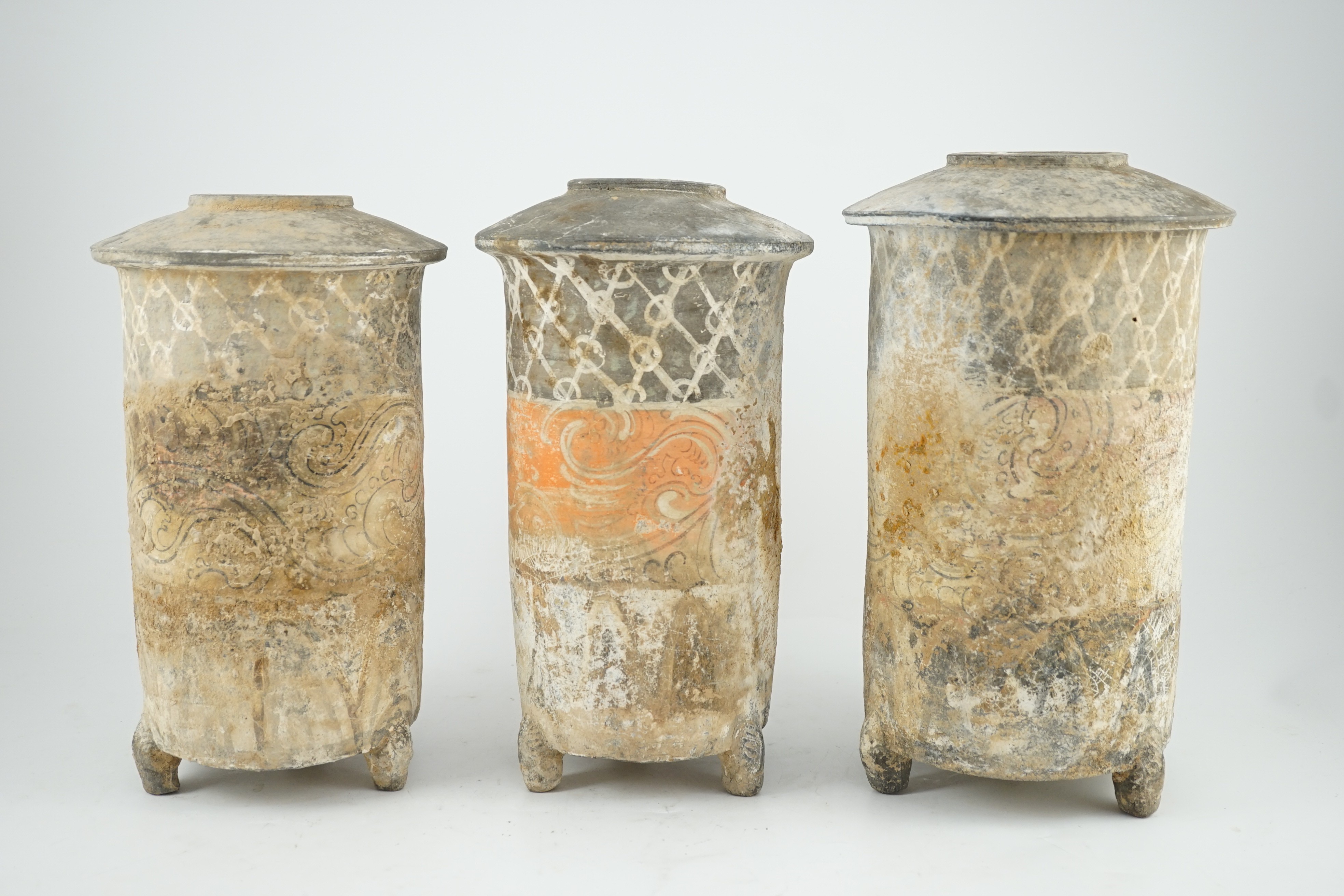 Three Chinese pigment painted grey pottery ‘granary’ jars, Han dynasty (200BCE - 220CE), 29.5 and 32cm high